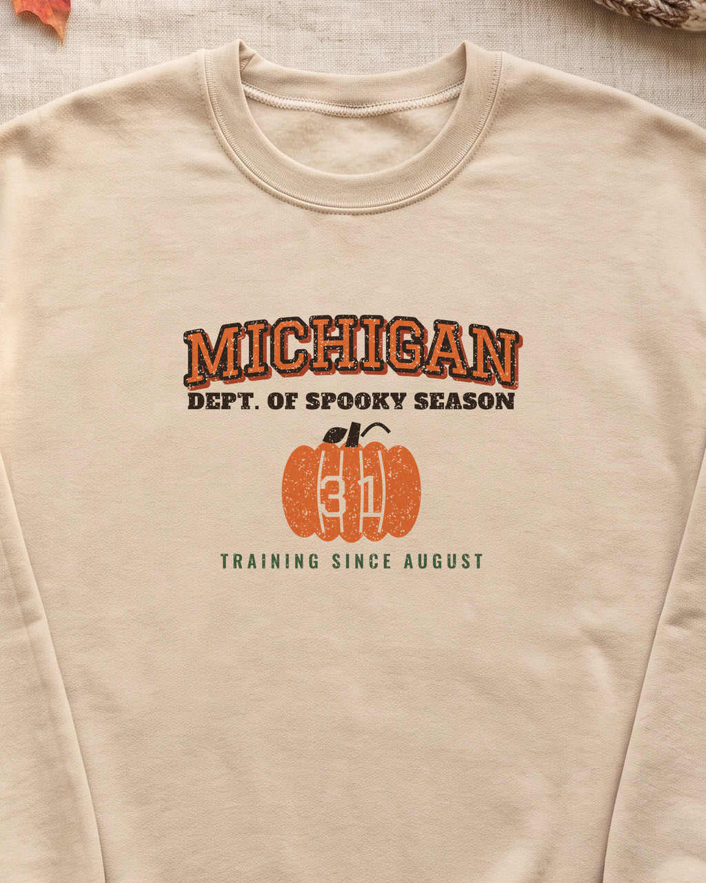 Michigan Dept. of Spooky Season Varsity Crewneck Sweatshirt (close-up)