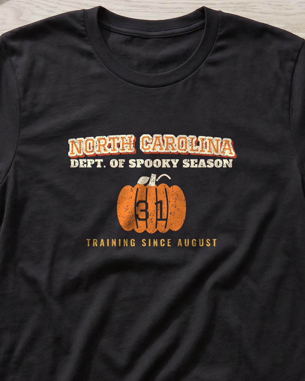 North Carolina Dept. of Spooky Season Varsity T-Shirt (close-up)