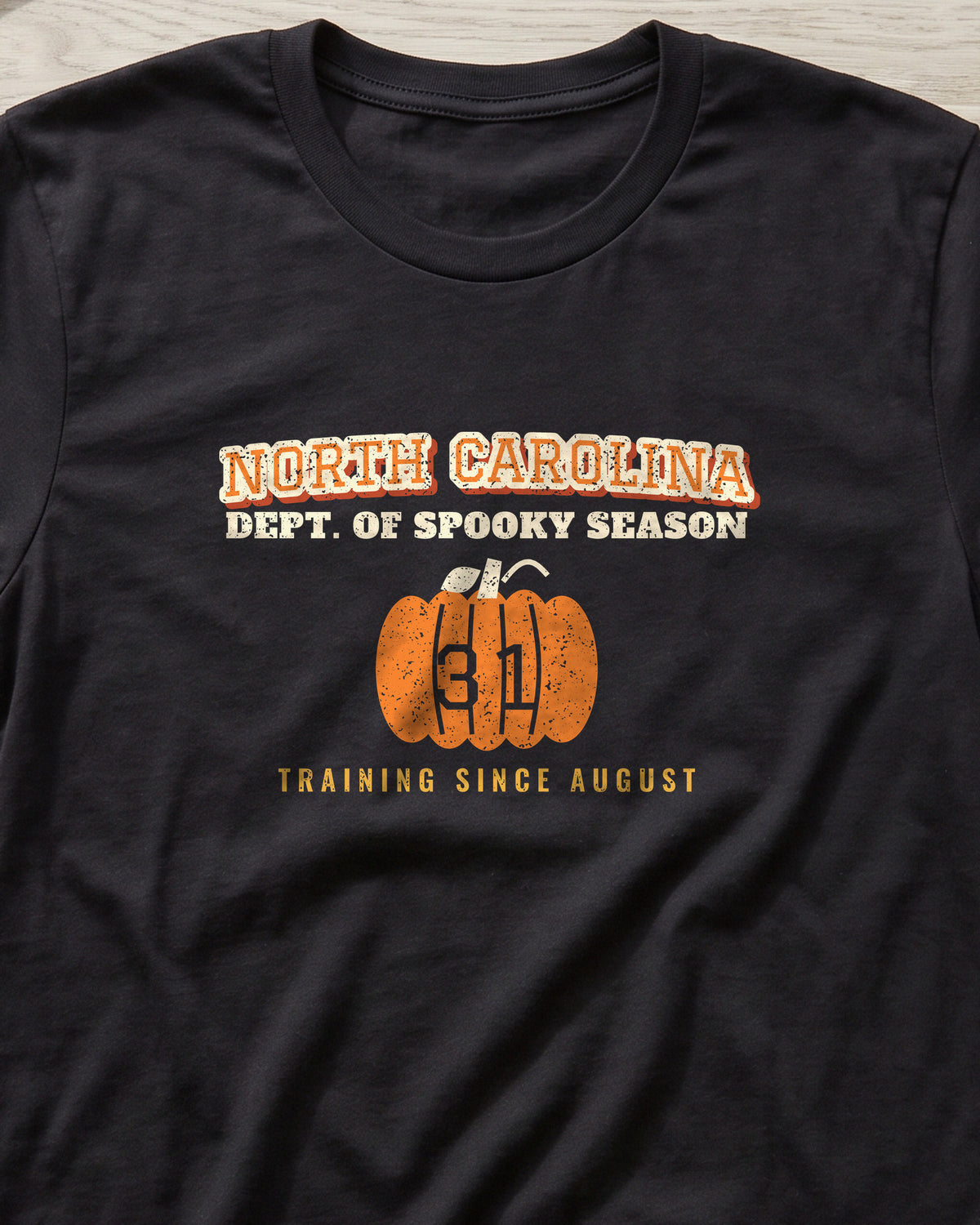 North Carolina Dept. of Spooky Season Varsity T-Shirt (close-up)
