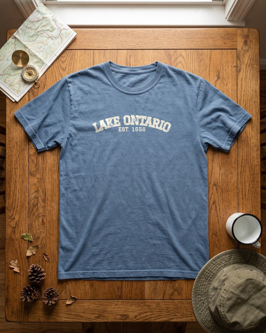 Blue T-shirt with a Lake Ontario design, laid flat