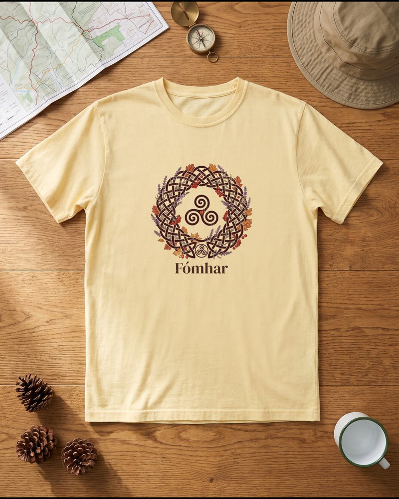 Butter-yellow T-shirt with a Fomhar autumn wreath design, laid flat